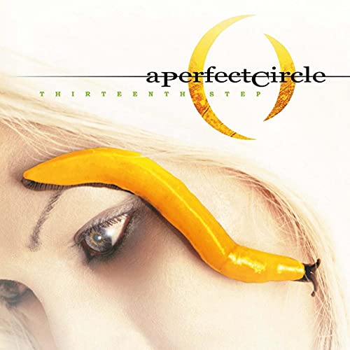 Album cover featuring a yellow slug on a person's face near their eye.