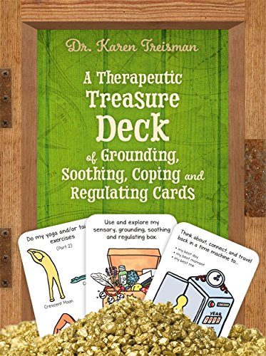 Card deck for emotional regulation rests on golden kinetic sand.