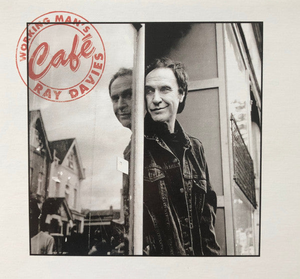 Black and white photo of Ray Davies reflected in a shop window.