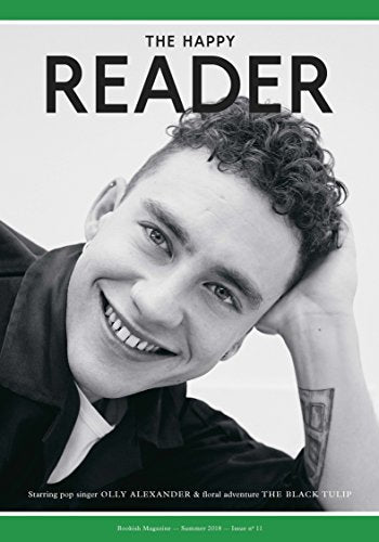 Magazine cover featuring a smiling young man with curly hair.