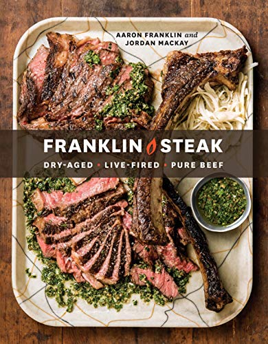 Cookbook cover featuring sliced and whole cooked steaks with green garnish.