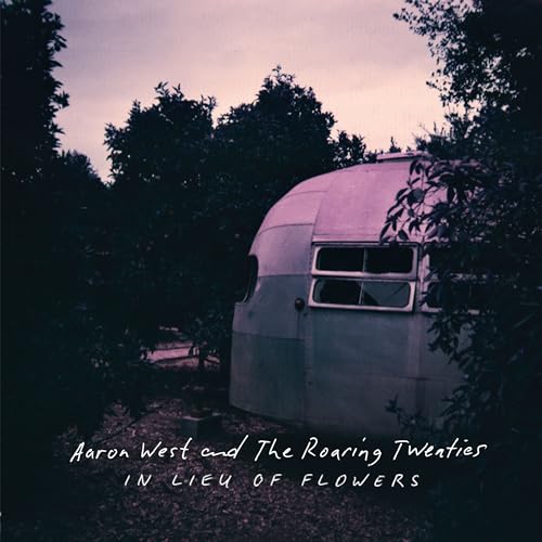 Vintage trailer in foliage, album cover for Aaron West and The Roaring Twenties.