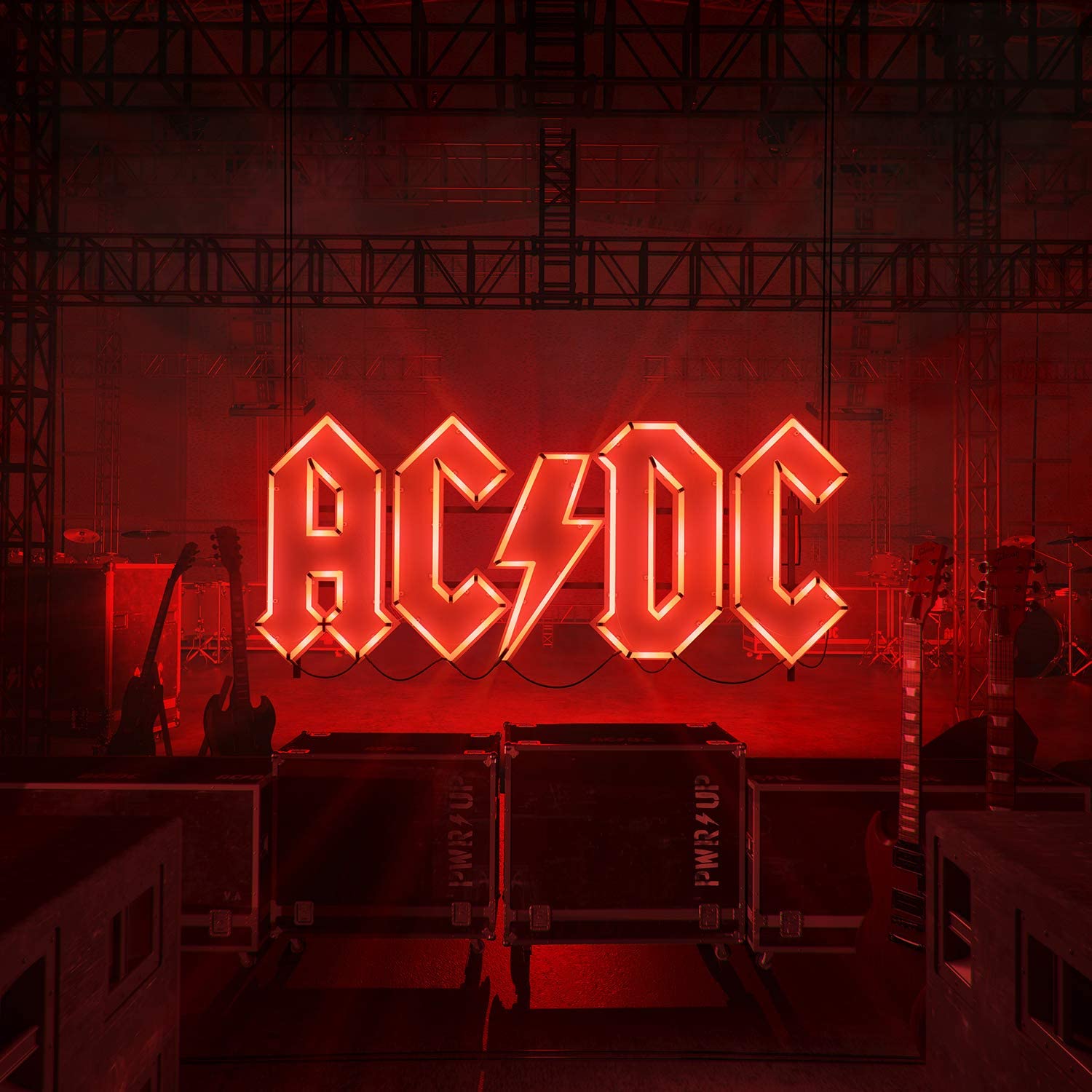 "AC/DC logo in red neon lights, surrounded by guitars and stage equipment."