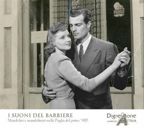 Black and white photo of a couple dancing in front of a shop.