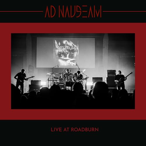 Black and white concert photo of a band performing onstage.