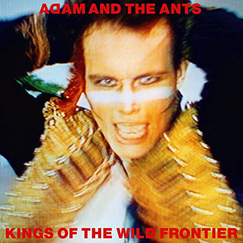 Adam Ant portrait with dramatic makeup and feathered collar, album cover.
