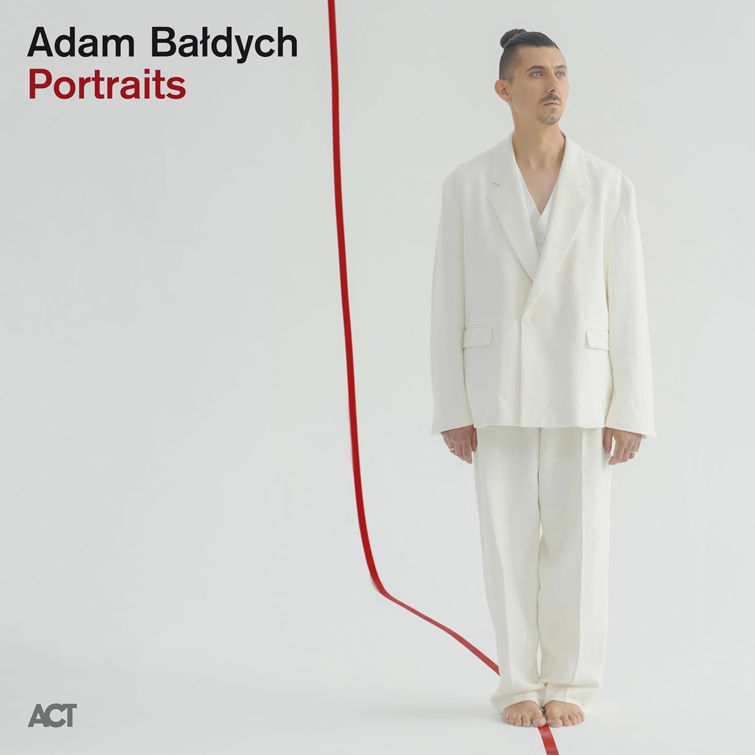 Album cover for Adam Baldych’s “Portraits” featuring a man in a suit.