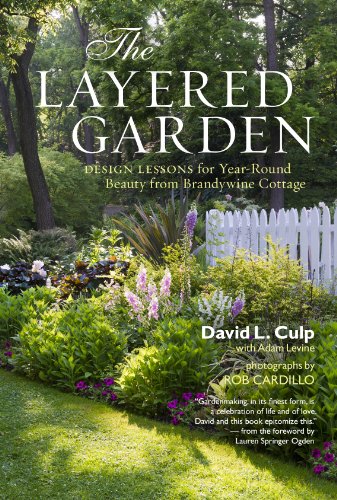 Book cover showing a lush garden with flowers and a white picket fence.