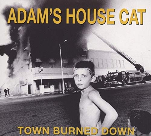 CD cover: black and white photo of a boy near a burning building.
