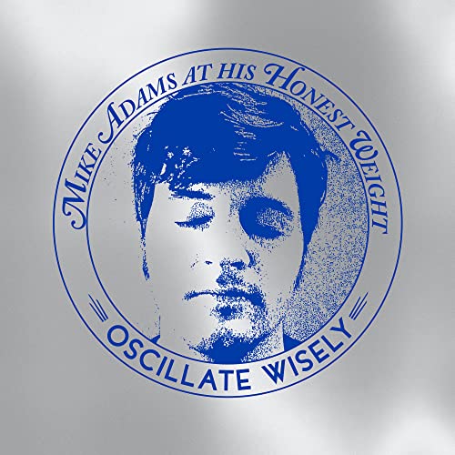 Circular album cover featuring a portrait of Mike Adams in blue and white.