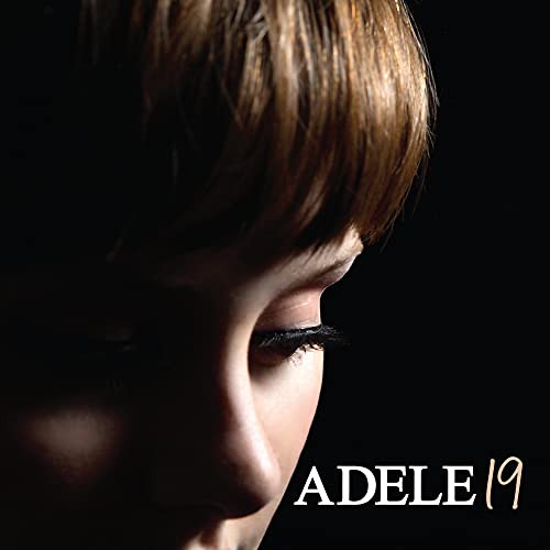 Close-up of Adele’s face with the album title “19” below.