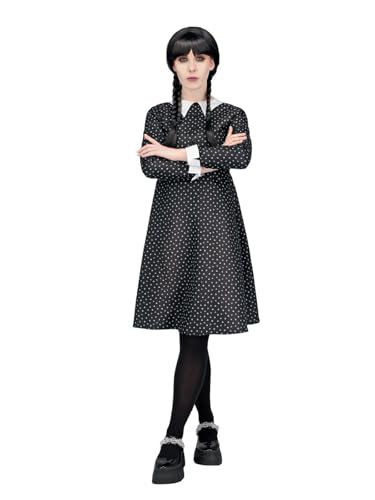 Woman in a black polka dot dress with white collar and pigtails.