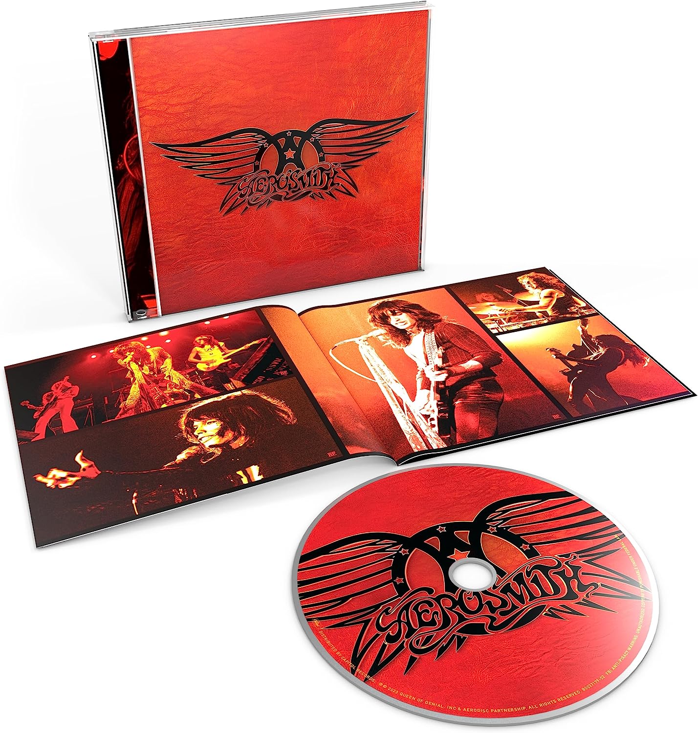 Aerosmith Greatest Hits CD case, open booklet with concert photos, and red branded disc.