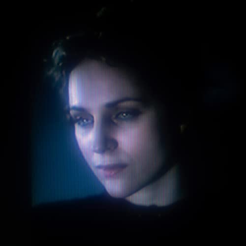 Close-up portrait of Agnes Obel with distorted, glitching visual effects.