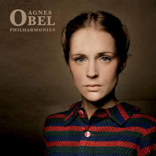 Agnes Obel's "Philharmonics" album cover: portrait of a woman with brown hair.