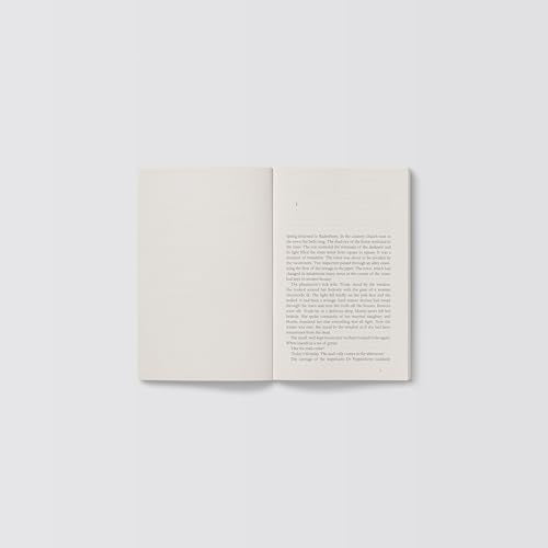 Open book with dense text on a pale background.