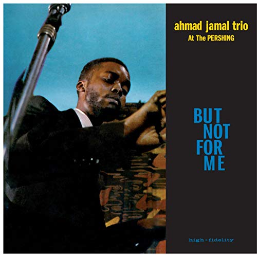 Ahmad Jamal playing piano with a microphone on a blue and black album cover.