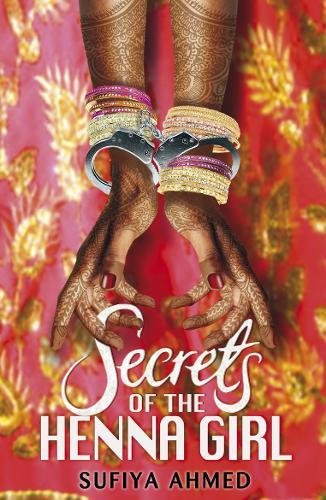 Hands with henna patterns wearing stacked bangles and handcuffs against a red floral background.