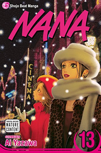 Two women in winter clothing stand in the snow in front of a cinema.