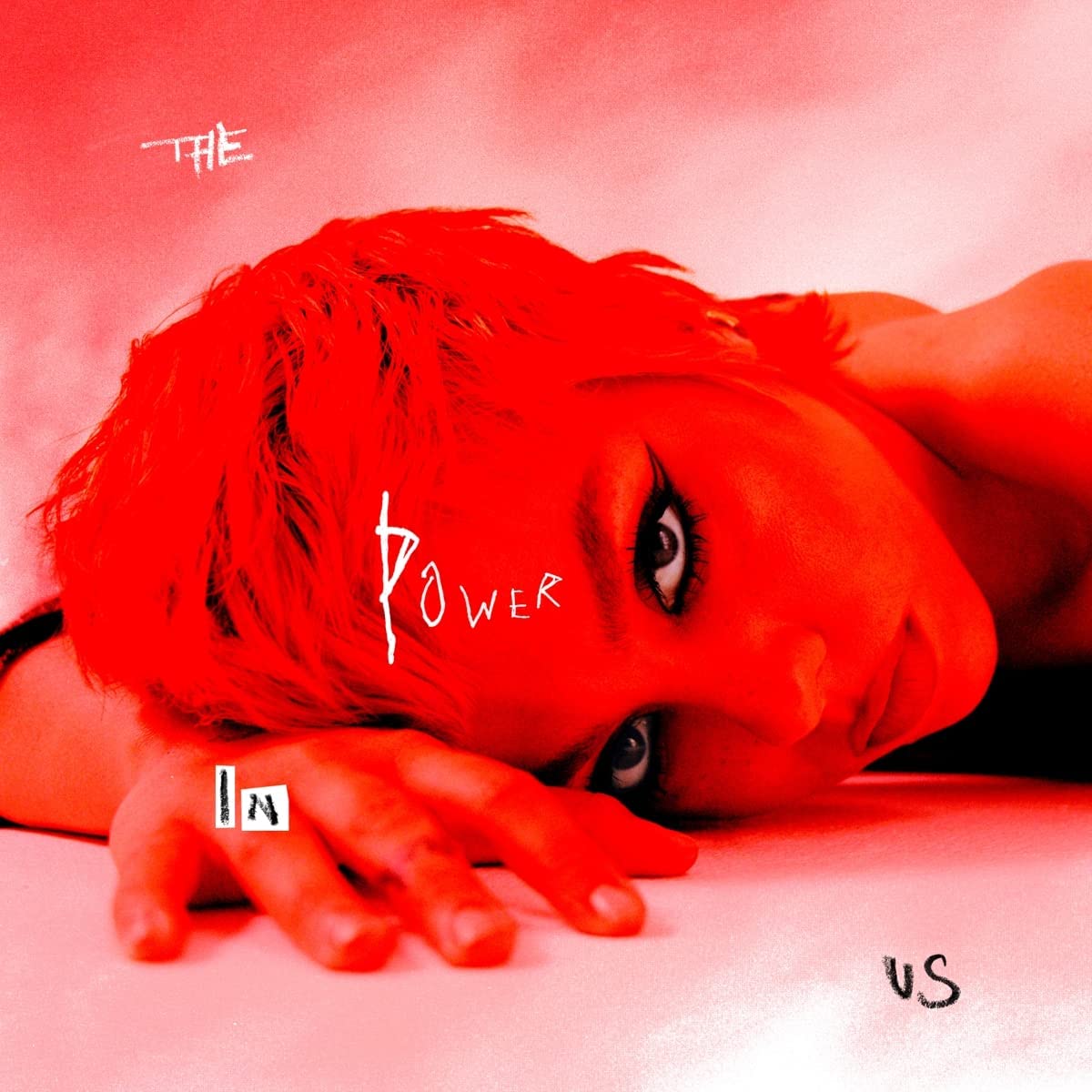 Red-toned album cover featuring a person’s face with overlaid text.