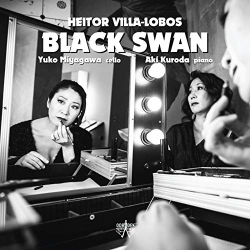 Black and white image of a woman applying makeup in front of a mirror.