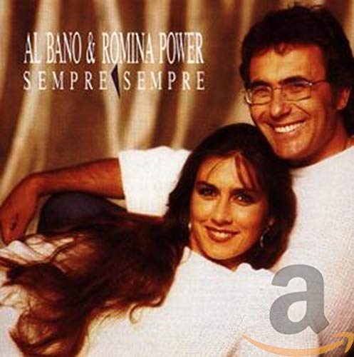Al Bano and Romina Power smiling together against a draped golden background.