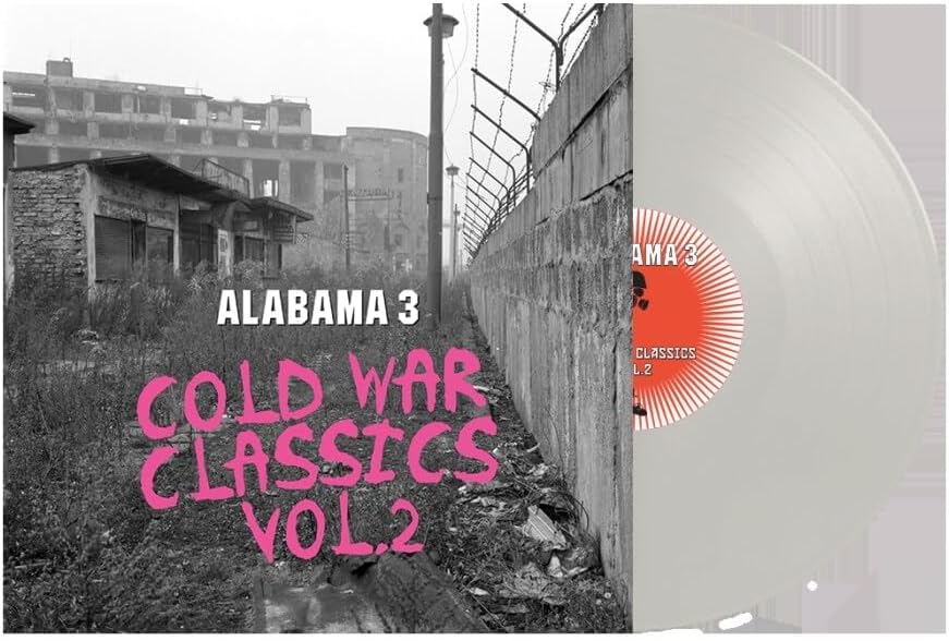 Alabama 3 album cover: derelict buildings, barbed wire, and a white vinyl record.