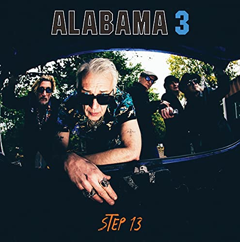 Alabama 3 album cover featuring a band viewed through a car window.