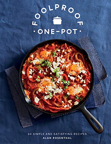 Cookbook cover with a vibrant image of eggs in a tomato sauce dish.