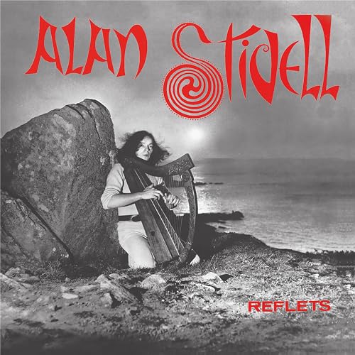 Alan Stivell album cover, man playing a Celtic harp by rocks and sea.