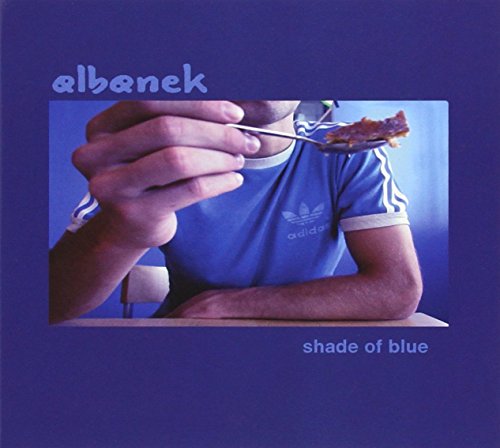 CD cover: man in blue shirt eating with a fork.