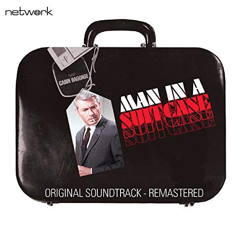 Black suitcase with a photo of a man and show title text.