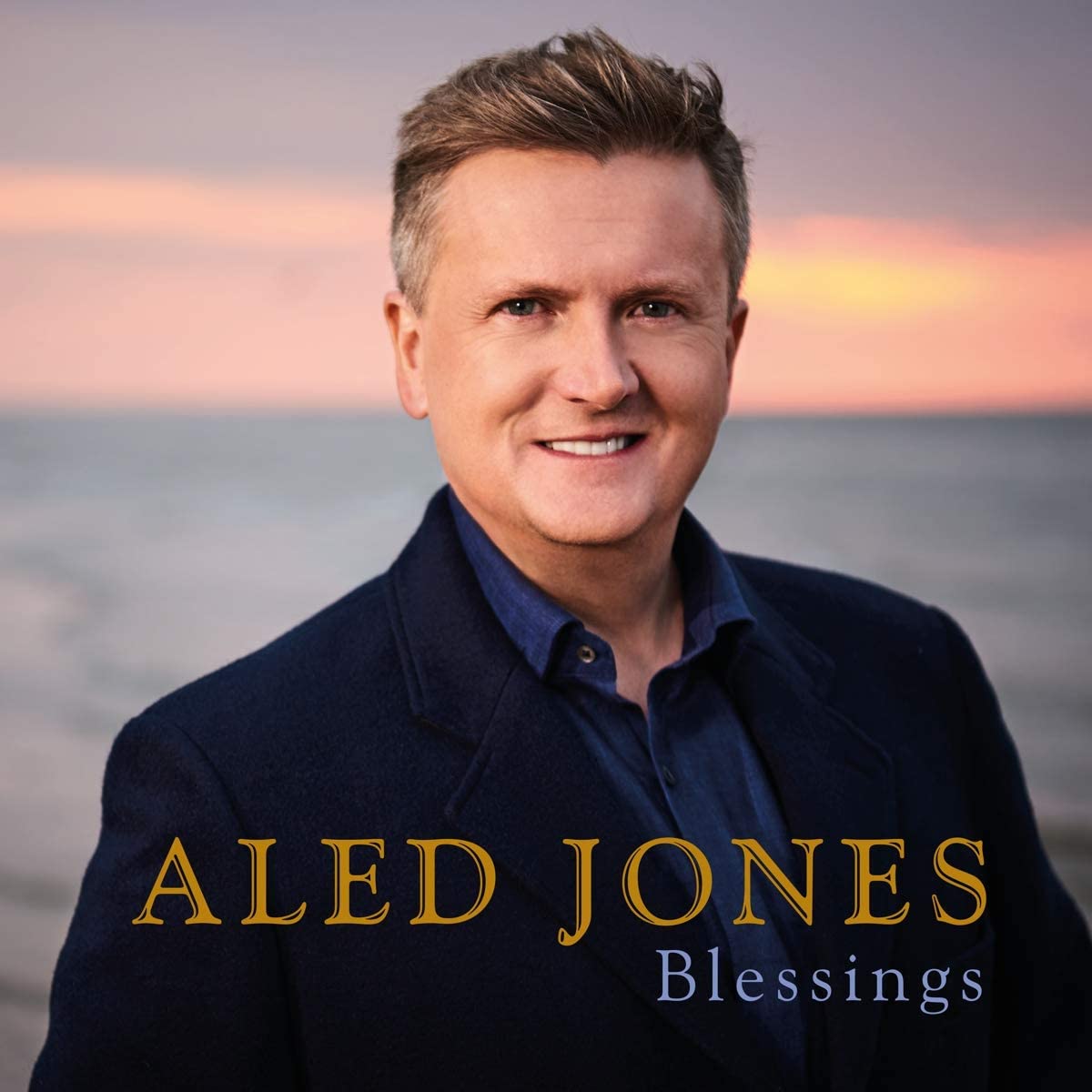 Aled Jones album cover featuring Aled Jones smiling in front of a sunset.