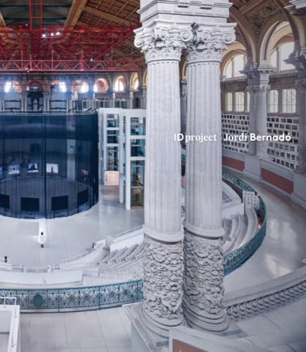 Interior view of a large hall with columns and a circular structure.