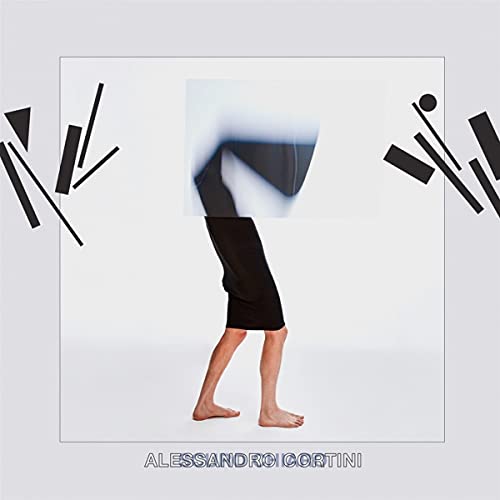 A barefoot person in black pants, blurred, on a light grey album cover.