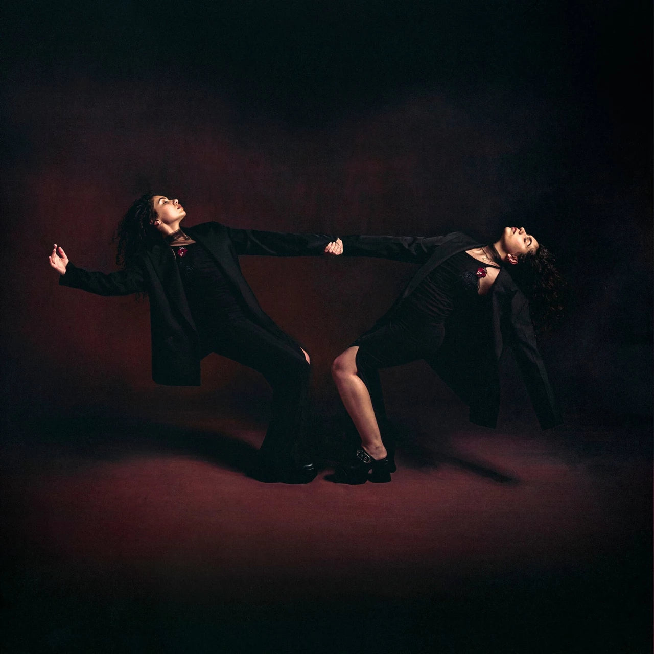 Alessia Cara album cover: two figures in dark clothing, dramatic poses.