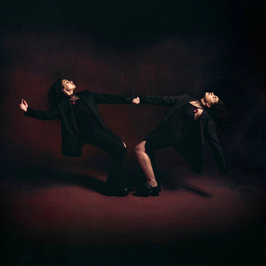Alessia Cara album cover: two figures in dark clothing, dramatic poses.