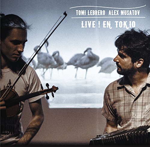 Two musicians playing violin and bandoneon with a background projection of flamingos.