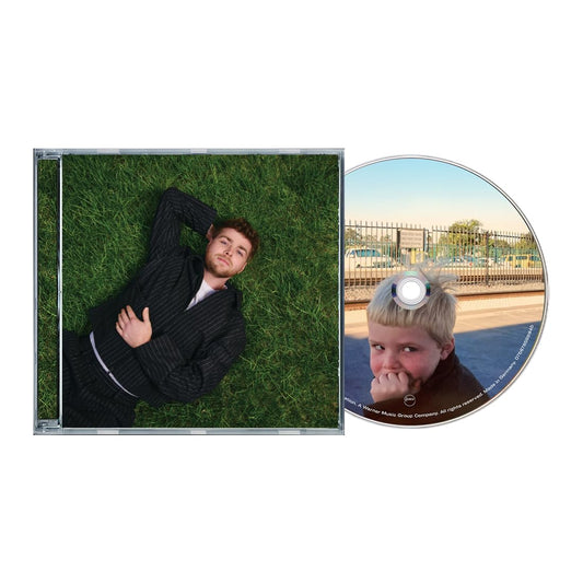 CD case featuring a man in a suit lying on artificial turf.