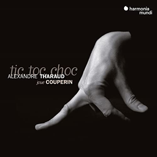 CD cover: a grayscale image of a hand playing piano, text “tic toc choc”.