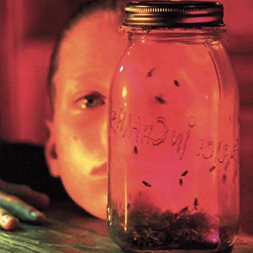 Red-tinted album cover featuring a jar of flies and blurred face.