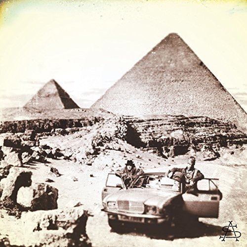 "Vintage-styled album cover: car with people near pyramids, sepia-toned image."