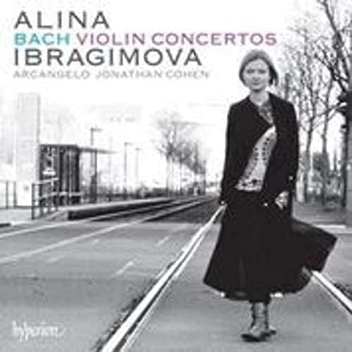 Black and white CD cover featuring a woman walking on tram tracks.