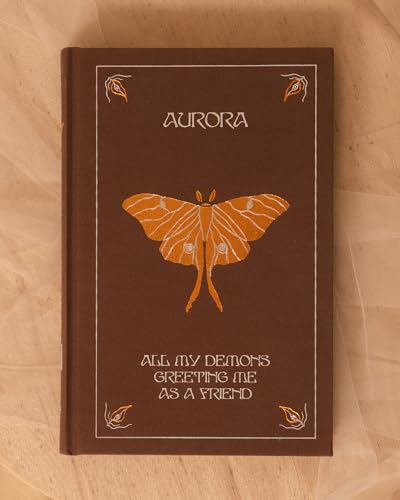 Brown hardcover book with a moth and the title "All My Demons.