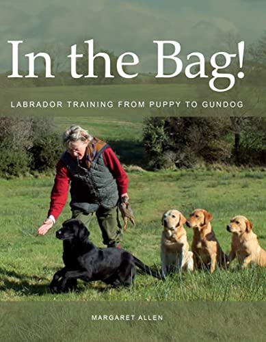 Book cover: trainer with black Labrador and three yellow Labradors in a field.