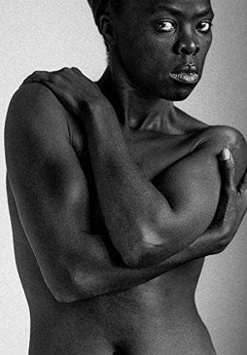 Black and white portrait of a person with arms crossed over chest.