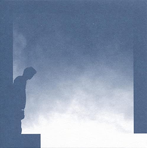 Blue album cover with silhouette of a man looking at clouds.