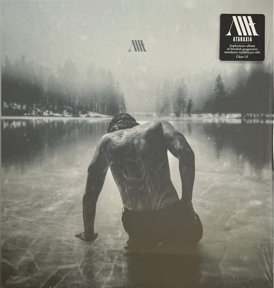 Vinyl album cover: a man in water with a forest background.