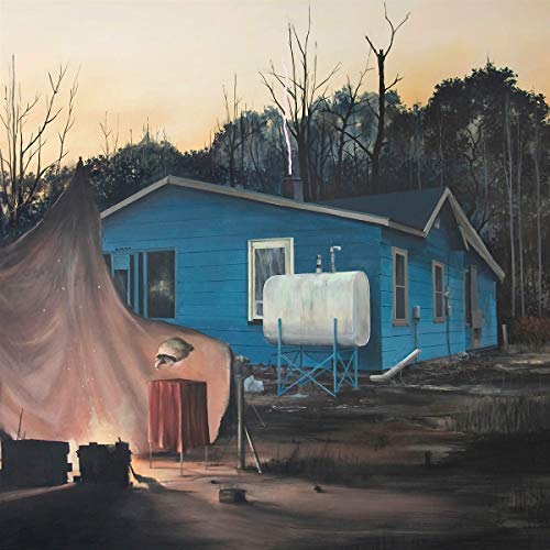 Blue house with a white tank, surrounded by trees and a tent.