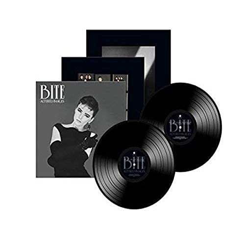 Black vinyl records and album cover featuring a woman in monochrome.